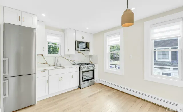 a kitchen with stainless steel appliances a refrigerator sink and stove