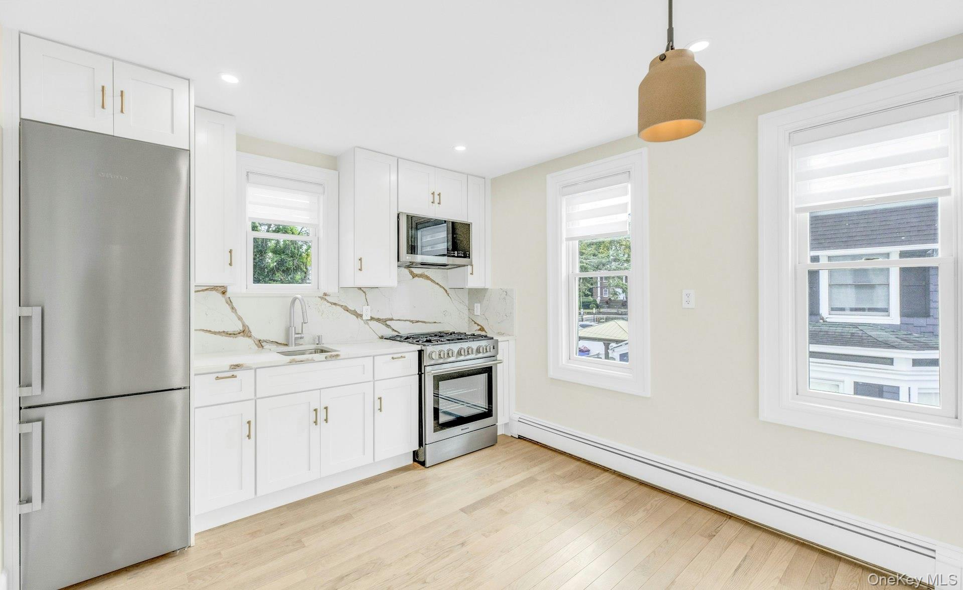 76 Green Street, Unit #2 Huntington, NY 11743 - Photo 9 of 28 a kitchen with stainless steel appliances a refrigerator sink and stove