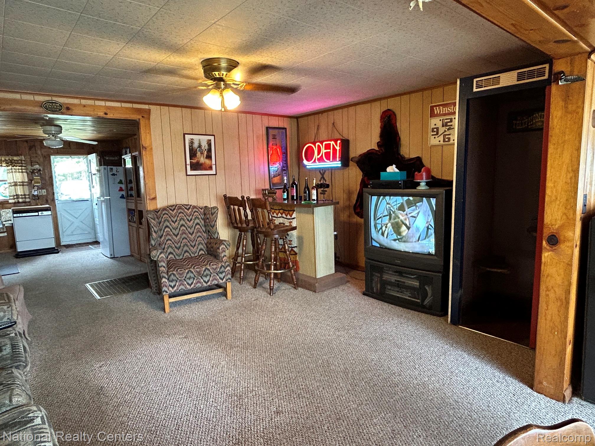 4951 Kokosing Road Hale, MI 48739 - Photo 20 of 37 Living room featuring ceiling fan, light carpet