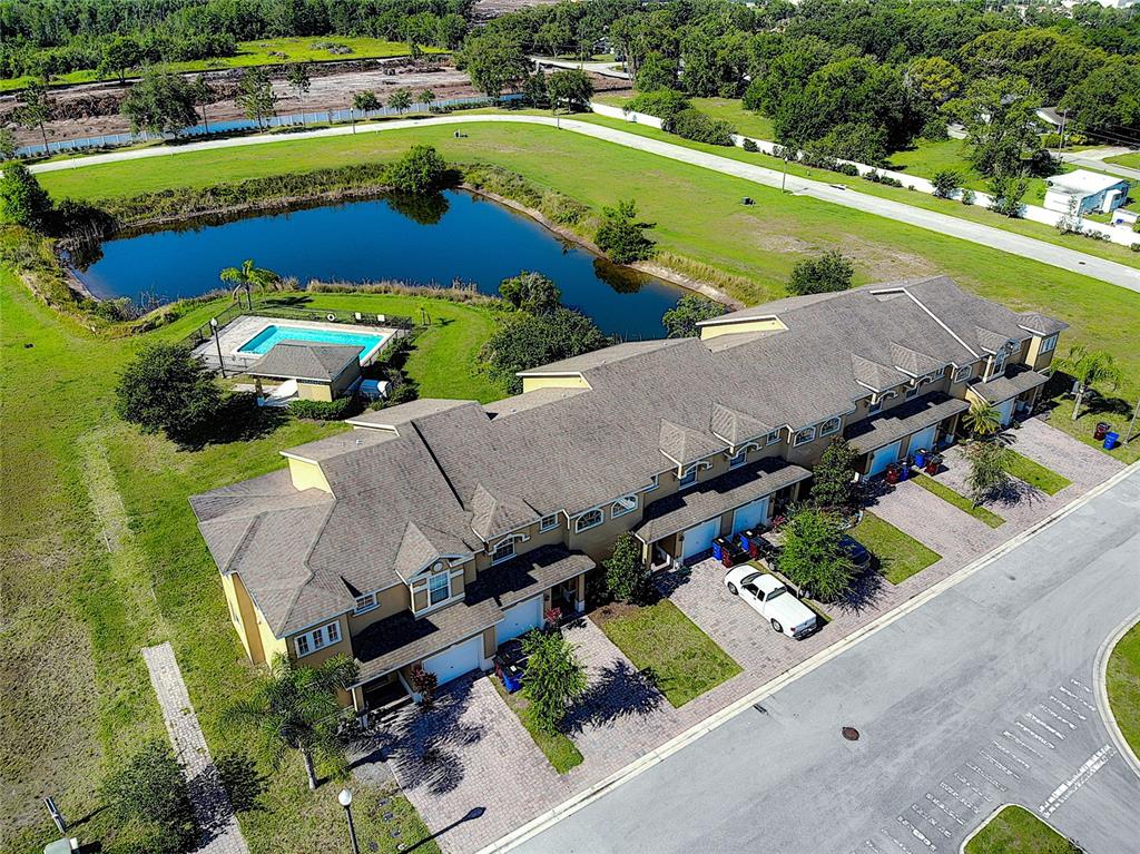 an aerial view of a house with a garden potted plants and large trees