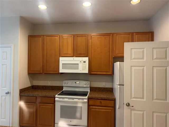 a kitchen with a stove and a refrigerator