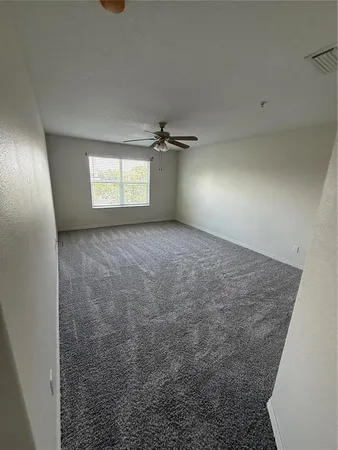 an empty room with a empty space and windows