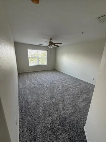 an empty room with a empty space and windows