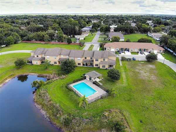 an aerial view of a house with a yard