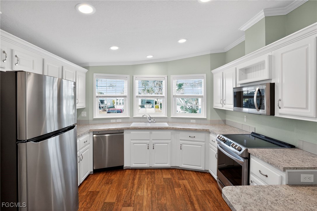 516 Menton Lane Naples, FL 34112 - Photo 13 of 34 a kitchen with stainless steel appliances granite countertop a refrigerator sink and microwave