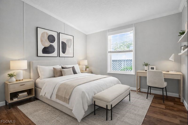 516 Menton Lane Naples, FL 34112 - Photo 17 of 34 a bedroom with a bed a table and chair