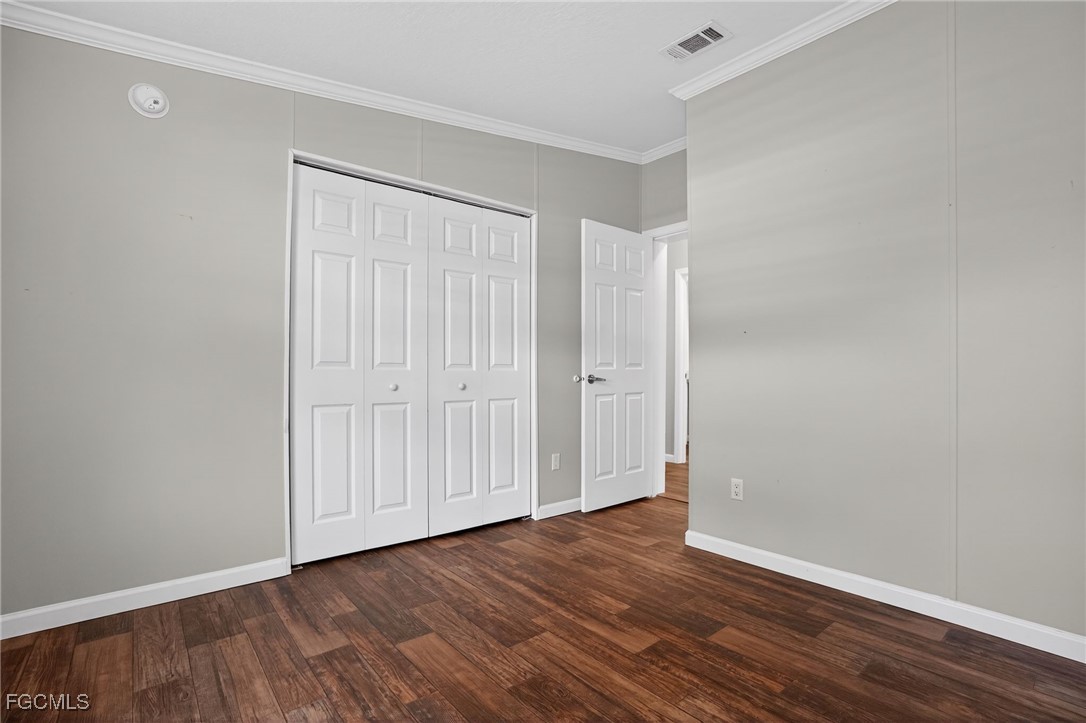 516 Menton Lane Naples, FL 34112 - Photo 18 of 34 a view of an empty room with wooden floor