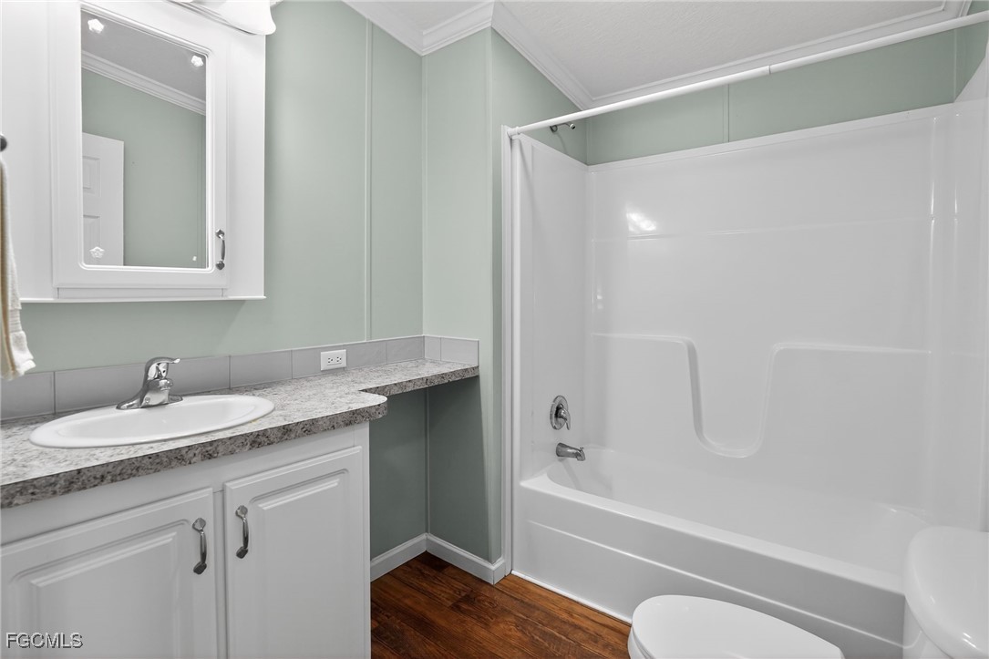 516 Menton Lane Naples, FL 34112 - Photo 19 of 34 a bathroom with a granite countertop sink toilet and shower