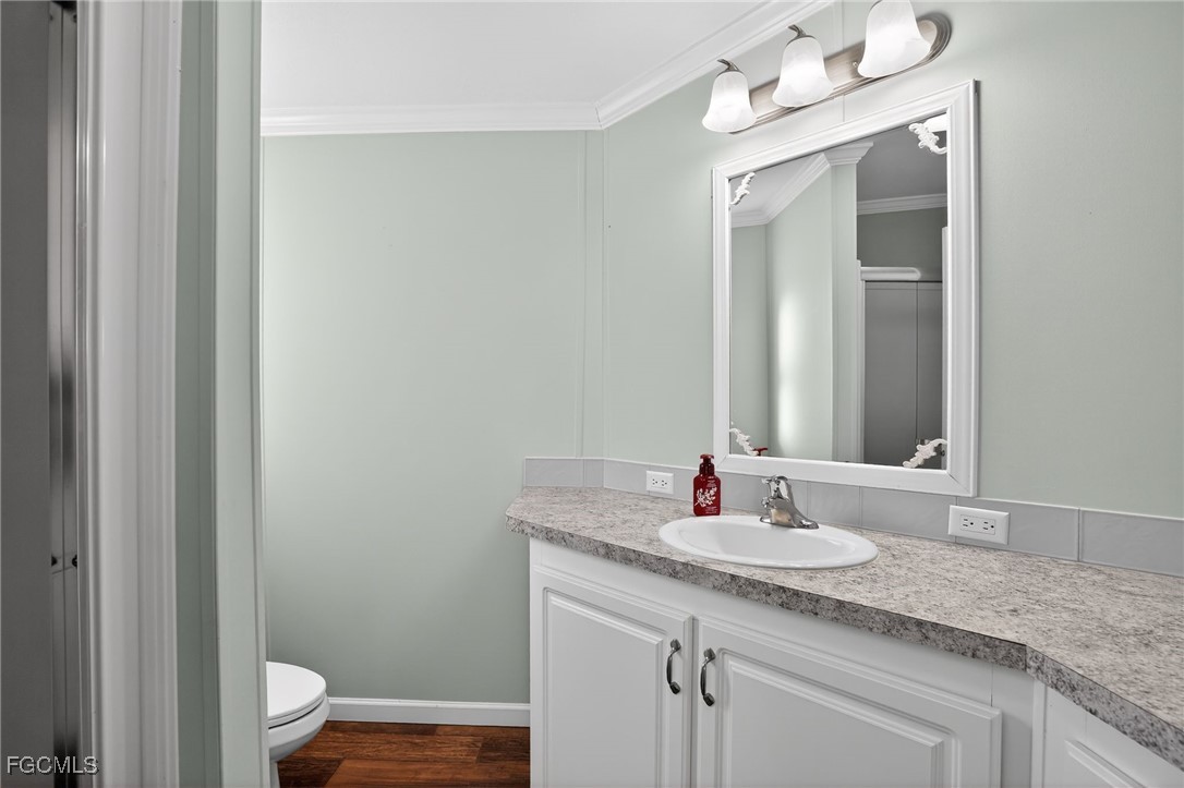 516 Menton Lane Naples, FL 34112 - Photo 23 of 34 a bathroom with a granite countertop sink and a mirror
