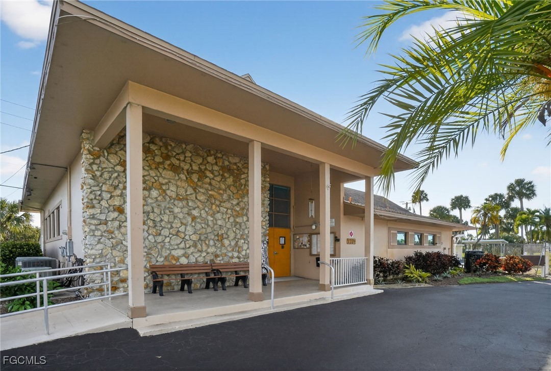 516 Menton Lane Naples, FL 34112 - Photo 34 of 34 a front view of a building with glass door and outdoor space