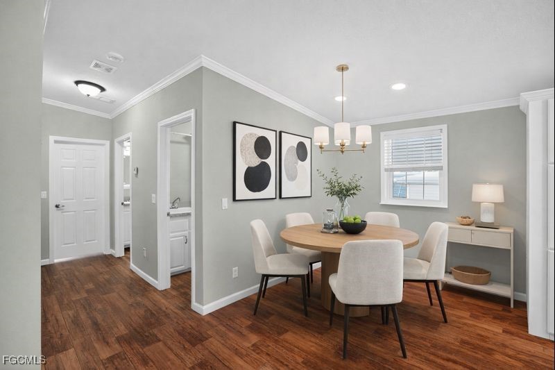 516 Menton Lane Naples, FL 34112 - Photo 9 of 34 a view of a a dining room with furniture window and wooden floor