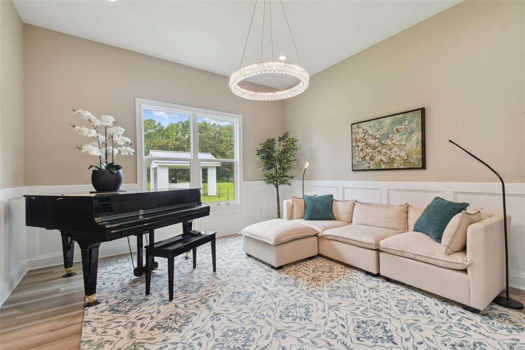 13711 Lussier Lane Spring Hill, FL 34610 - Photo 17 of 100 a living room with furniture a table and a large window