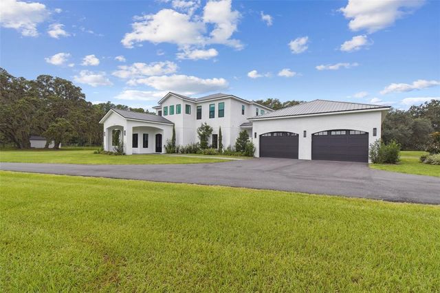 a spacious bathroom with a granite countertop sink a mirror and shower