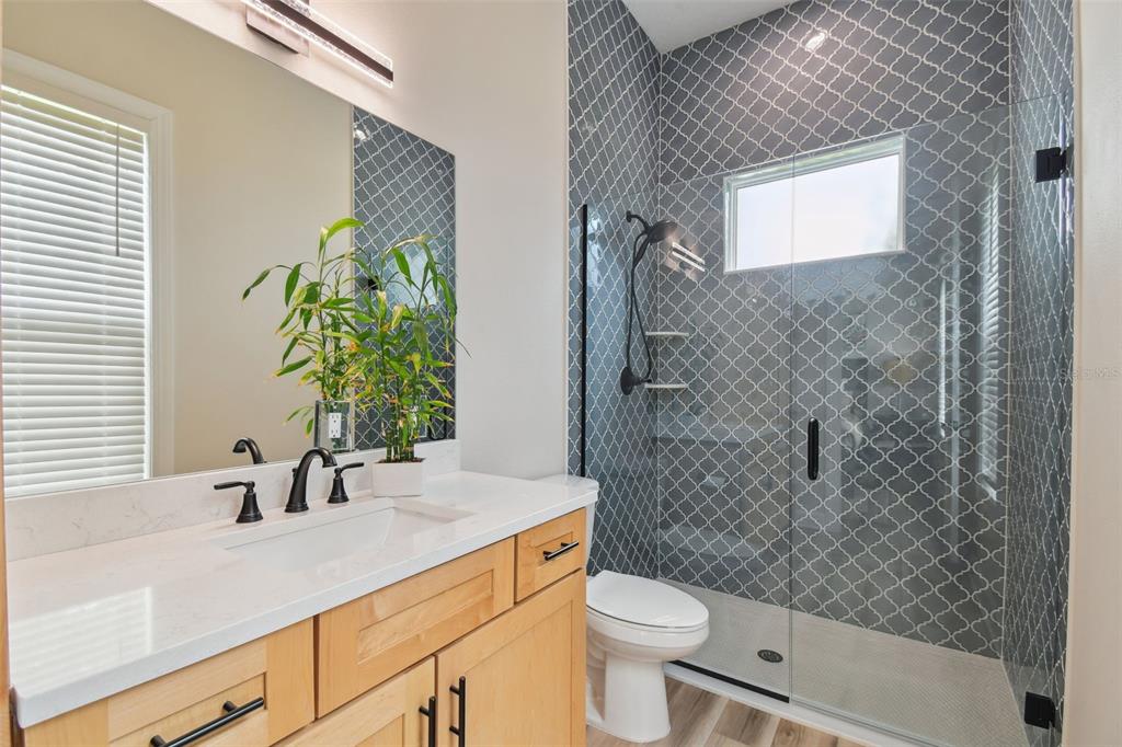 13711 Lussier Lane Spring Hill, FL 34610 - Photo 34 of 100 a bathroom with a sink a toilet and shower