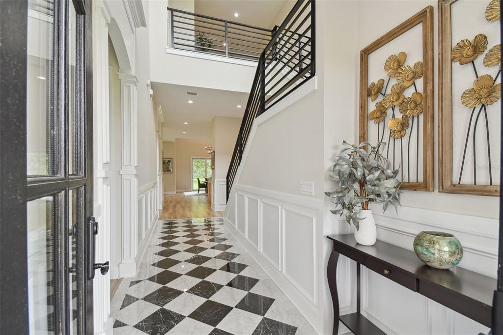 13711 Lussier Lane Spring Hill, FL 34610 - Photo 4 of 100 a view of a hallway with wooden floor and staircase