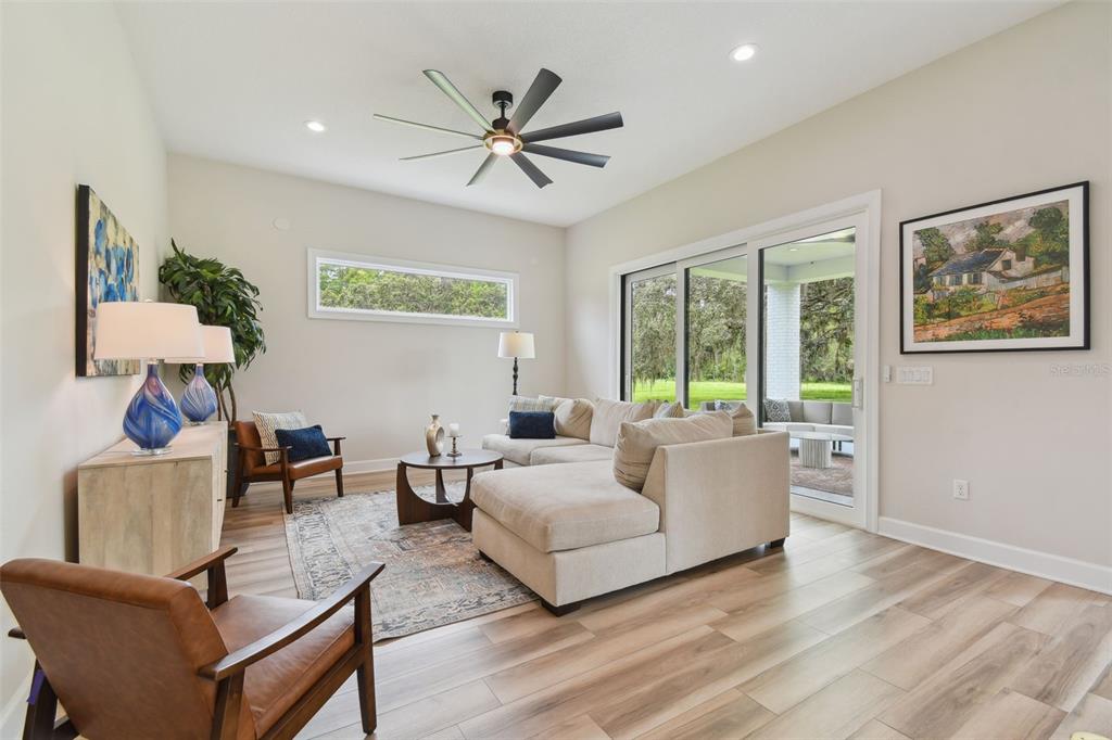 13711 Lussier Lane Spring Hill, FL 34610 - Photo 57 of 100 a living room with furniture and a large window