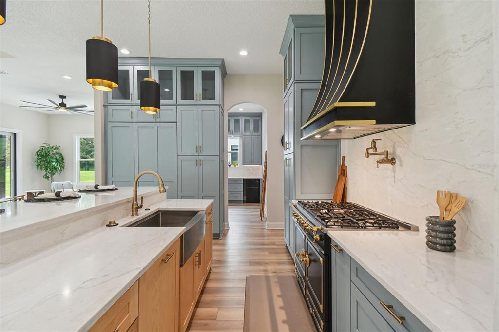 13711 Lussier Lane Spring Hill, FL 34610 - Photo 6 of 100 a kitchen with stainless steel appliances granite countertop a sink stove and refrigerator