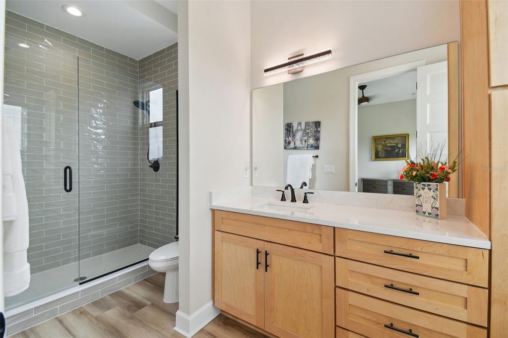 13711 Lussier Lane Spring Hill, FL 34610 - Photo 66 of 100 a bathroom with a double vanity sink toilet and shower