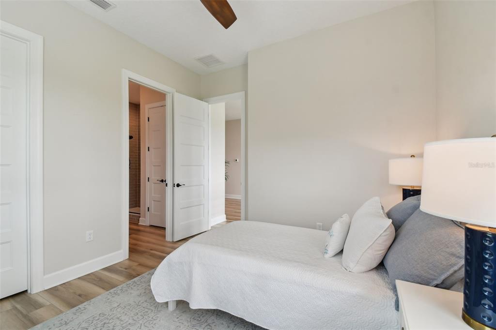 13711 Lussier Lane Spring Hill, FL 34610 - Photo 68 of 100 a bedroom with a bed and a night stand