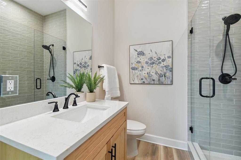 13711 Lussier Lane Spring Hill, FL 34610 - Photo 69 of 100 a bathroom with a sink a toilet and shower