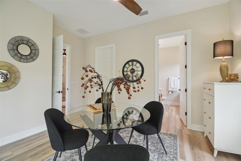 13711 Lussier Lane Spring Hill, FL 34610 - Photo 74 of 100 a view of a dining room with furniture and wooden floor