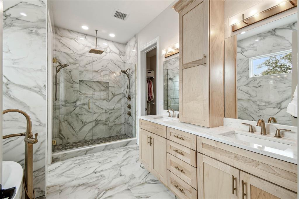 13711 Lussier Lane Spring Hill, FL 34610 - Photo 86 of 100 a bathroom with a granite countertop sink a mirror a shower and a bathtub