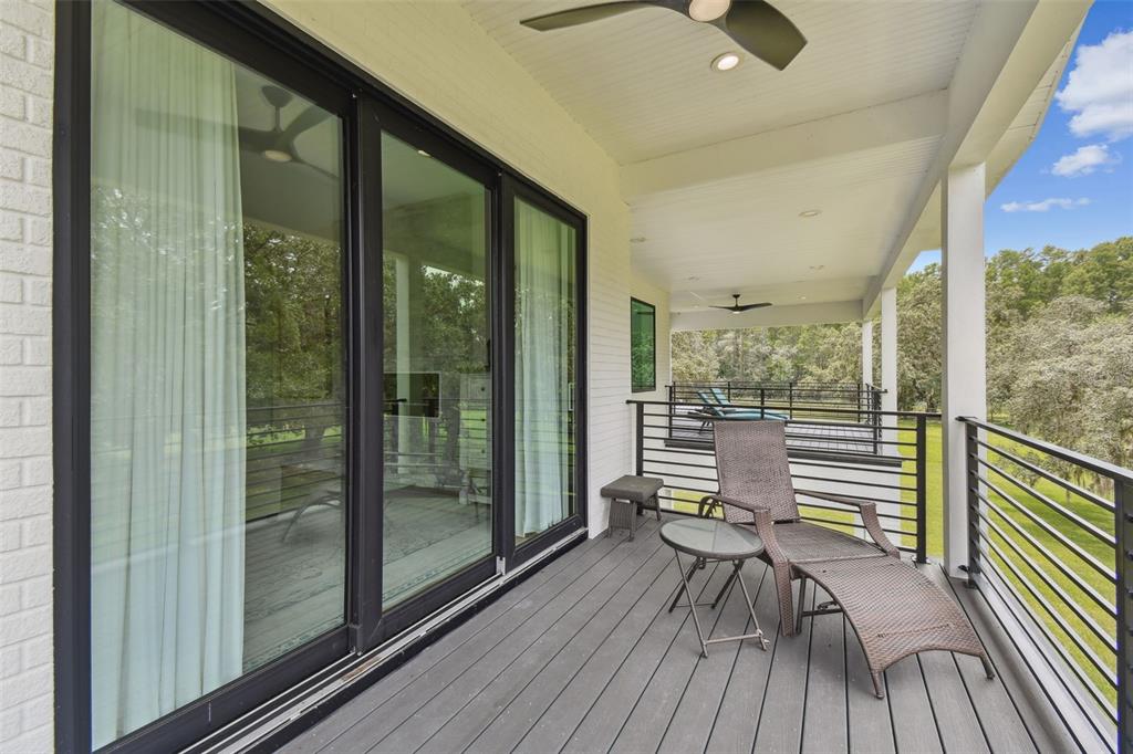13711 Lussier Lane Spring Hill, FL 34610 - Photo 88 of 100 a view of a balcony with chairs and wooden floor