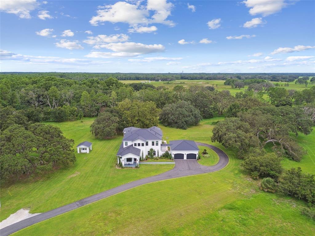 13711 Lussier Lane Spring Hill, FL 34610 - Photo 93 of 100 a front view of a house with a garden