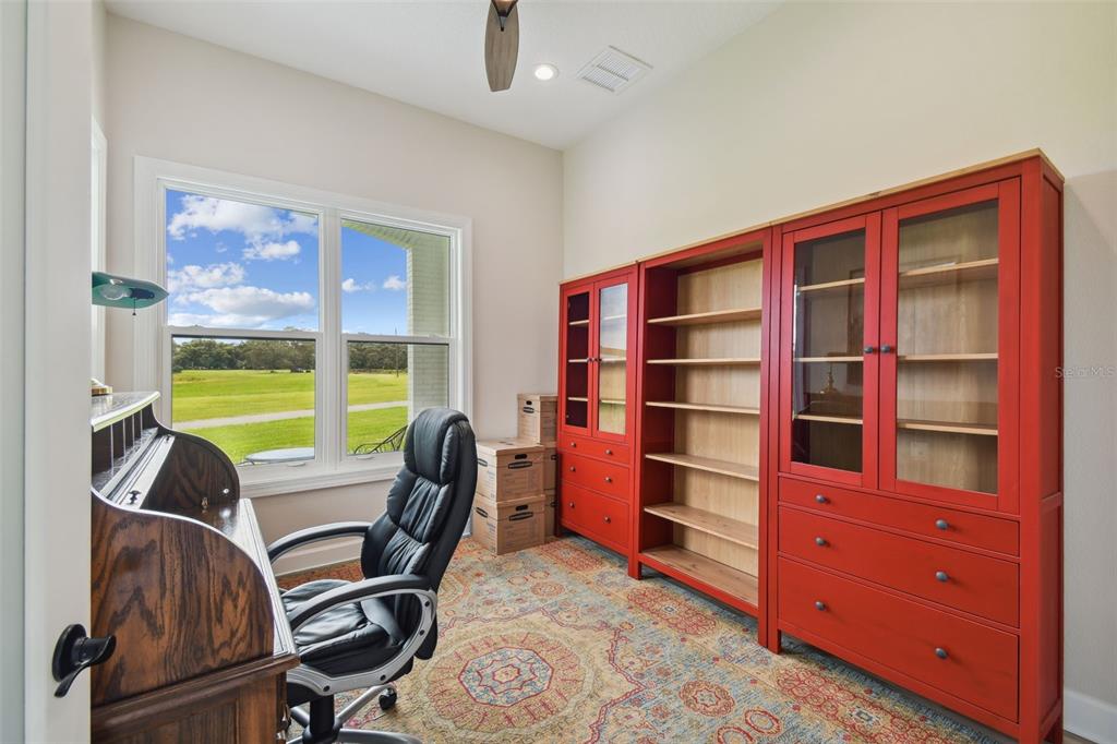 13711 Lussier Lane Spring Hill, FL 34610 - Photo 10 of 100 a view of a workspace with furniture and a window