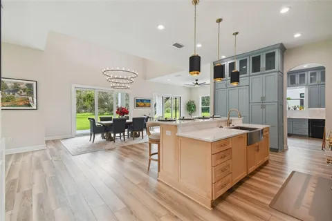 a living room with furniture a table and a large window