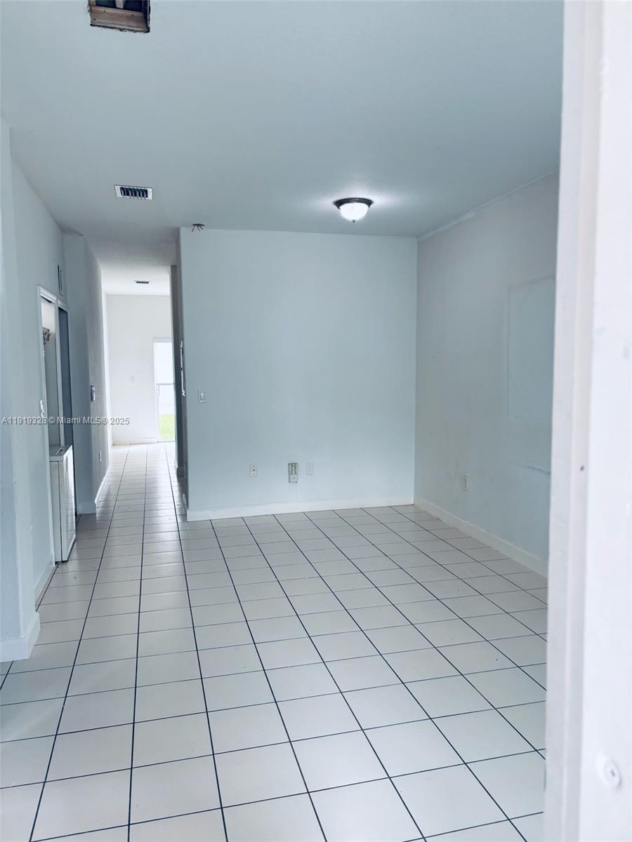 1663 Southeast 29th Street, Unit 100 Homestead, FL 33035 - Photo 3 of 15 a view of an empty room and a hallway