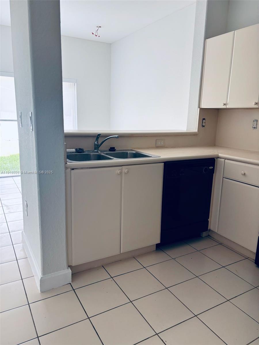 1663 Southeast 29th Street, Unit 100 Homestead, FL 33035 - Photo 4 of 15 a kitchen with a cabinets