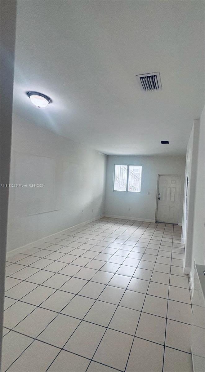 1663 Southeast 29th Street, Unit 100 Homestead, FL 33035 - Photo 9 of 15 a view of an empty room and window