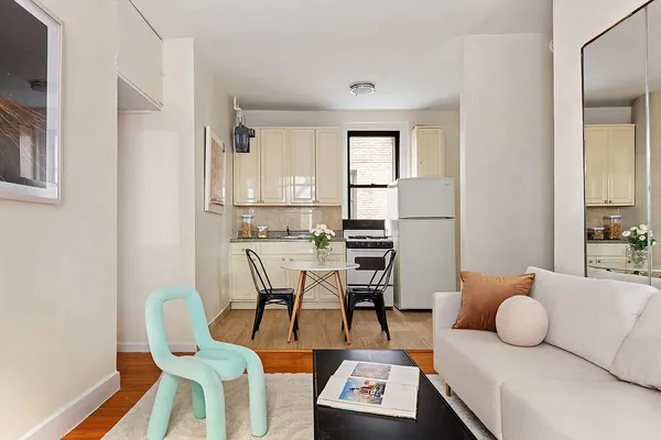 a living room with furniture a rug and a table
