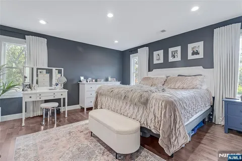 a bedroom with a large bed a table and chair