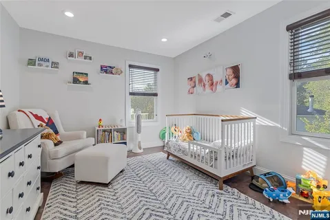 a bedroom with furniture and a wooden floor