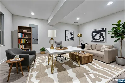 a living room with furniture a rug and a table