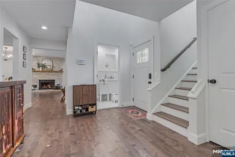 a view of a livingroom with wooden floor and furniture