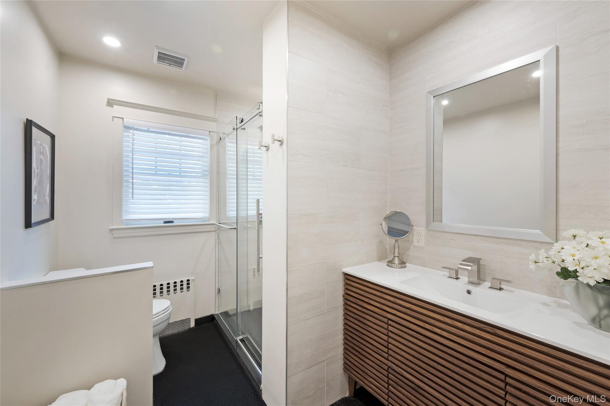 60 Aberfoyle Road New Rochelle, NY 10804 - Photo 16 of 26 a bathroom with a sink and a mirror