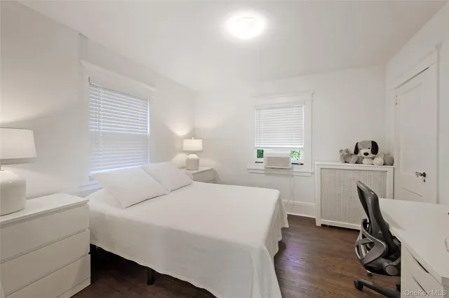 a bedroom with a bed and a desk in it