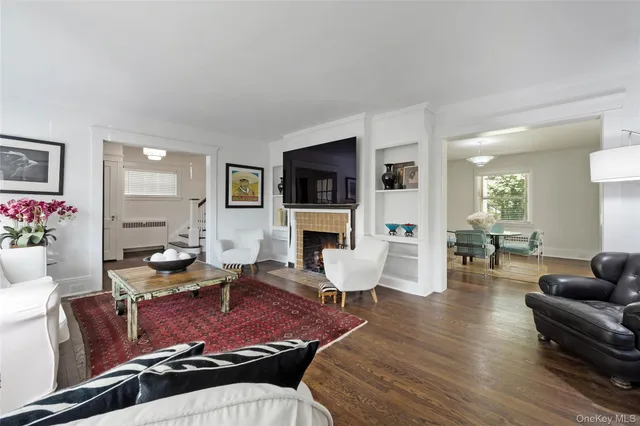 a living room with fireplace furniture and a flat screen tv