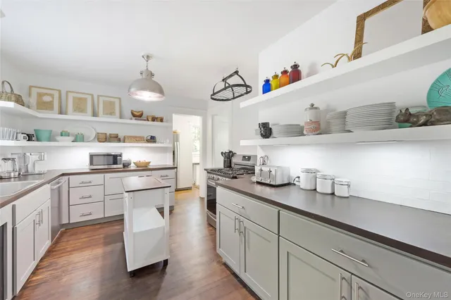 a kitchen with cabinets a sink and appliances