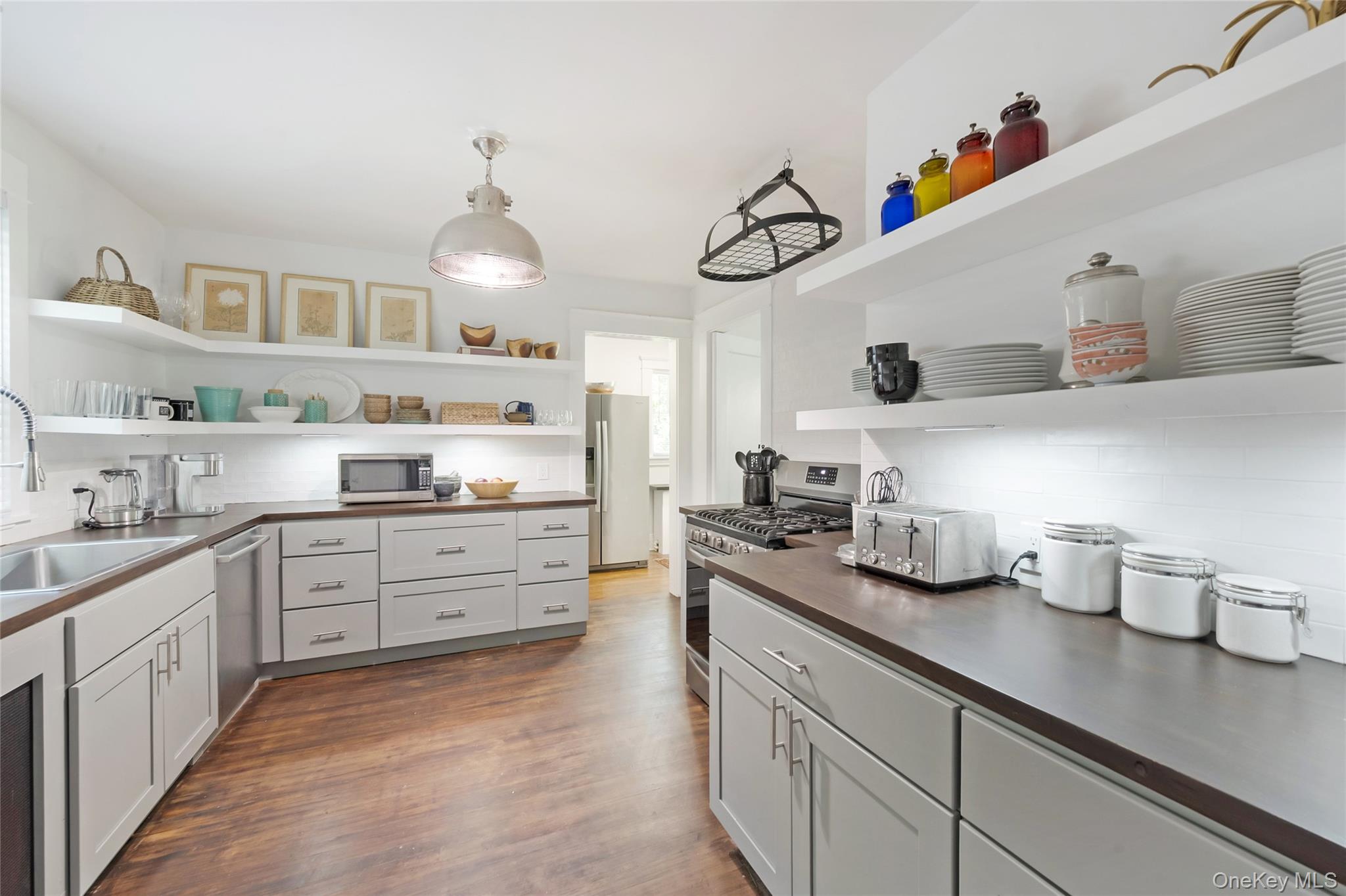 60 Aberfoyle Road New Rochelle, NY 10804 - Photo 6 of 26 a kitchen with kitchen island white cabinets and white appliances