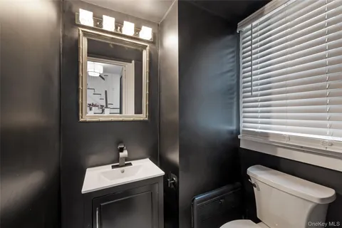 a bathroom with a toilet sink and mirror