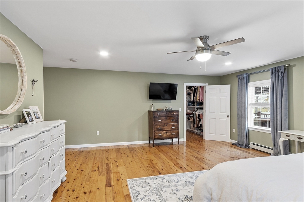 90 South Road Pepperell, MA 01463 - Photo 17 of 41 a spacious bedroom with a bed and a flat screen tv