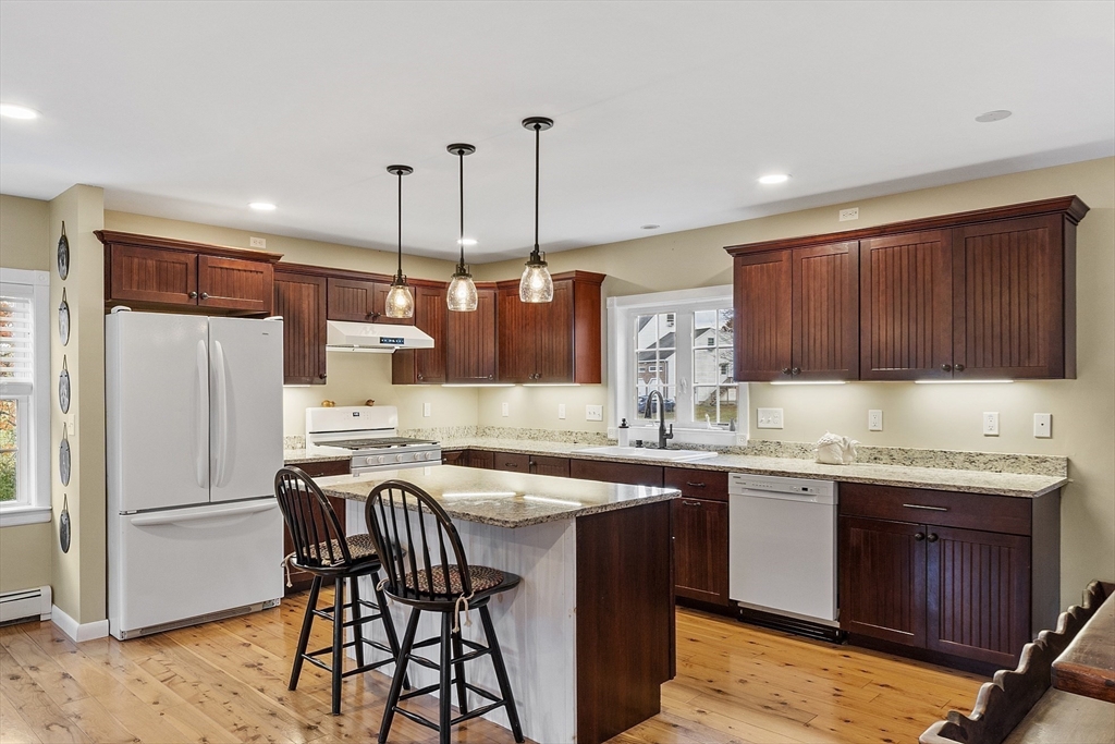 90 South Road Pepperell, MA 01463 - Photo 10 of 41 a kitchen with a sink stove and wooden cabinets