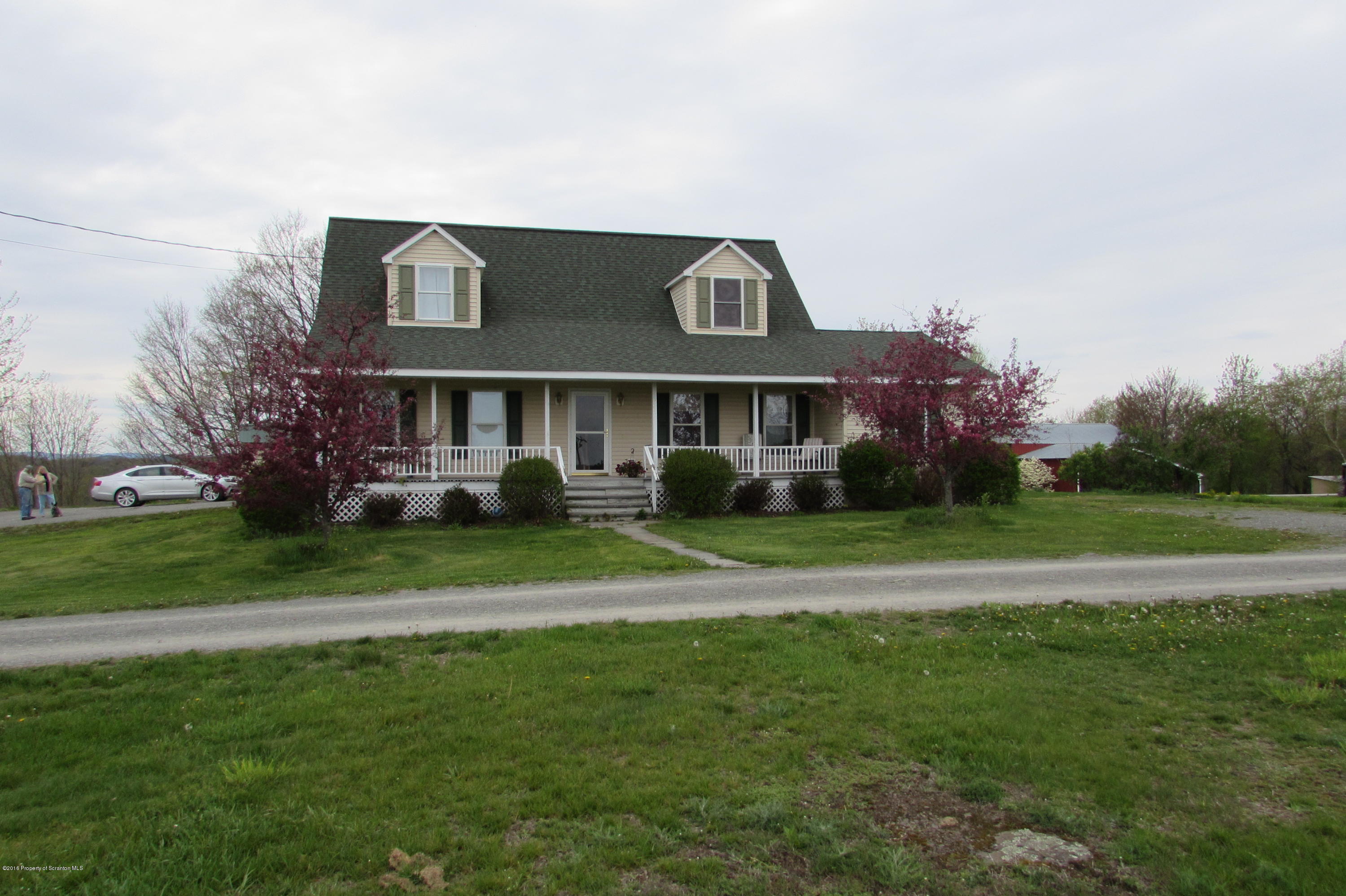 a front view of a house with a yard table and chairs