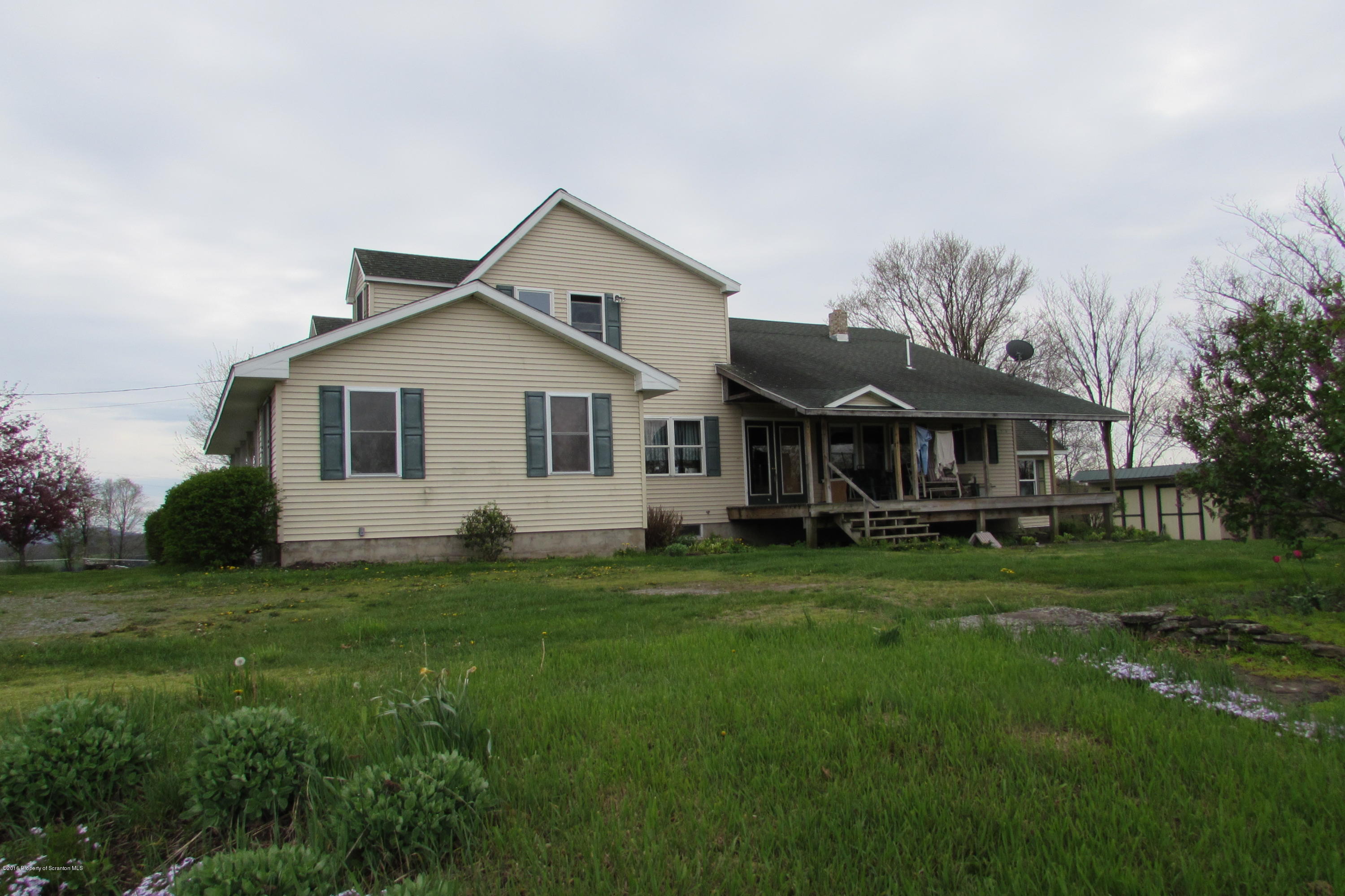 637 Craig Hill Road Meshoppen, PA 18630 - Photo 15 of 22 a front view of a house with a garden