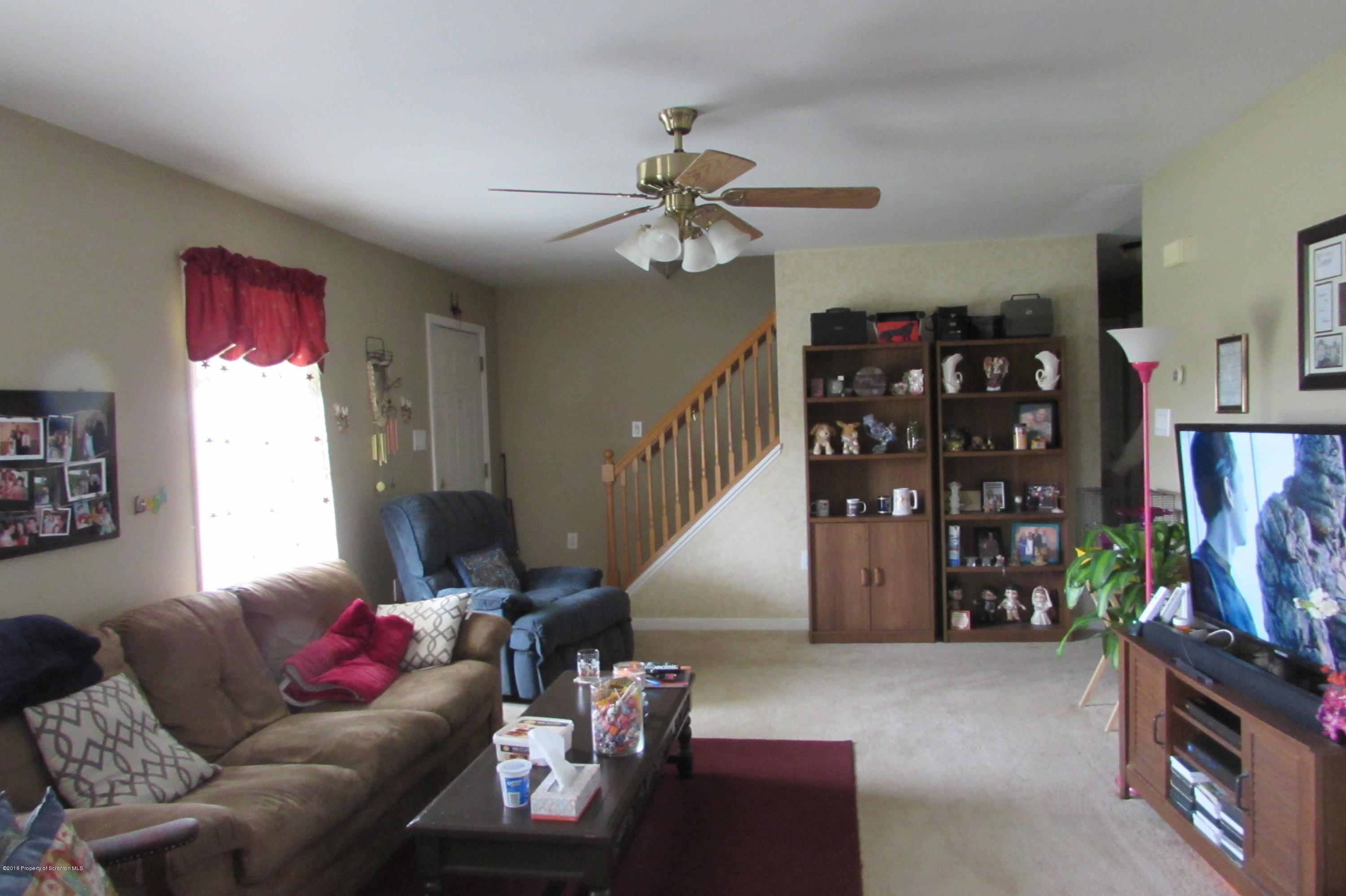 637 Craig Hill Road Meshoppen, PA 18630 - Photo 3 of 22 a living room with furniture a ceiling fan and a window