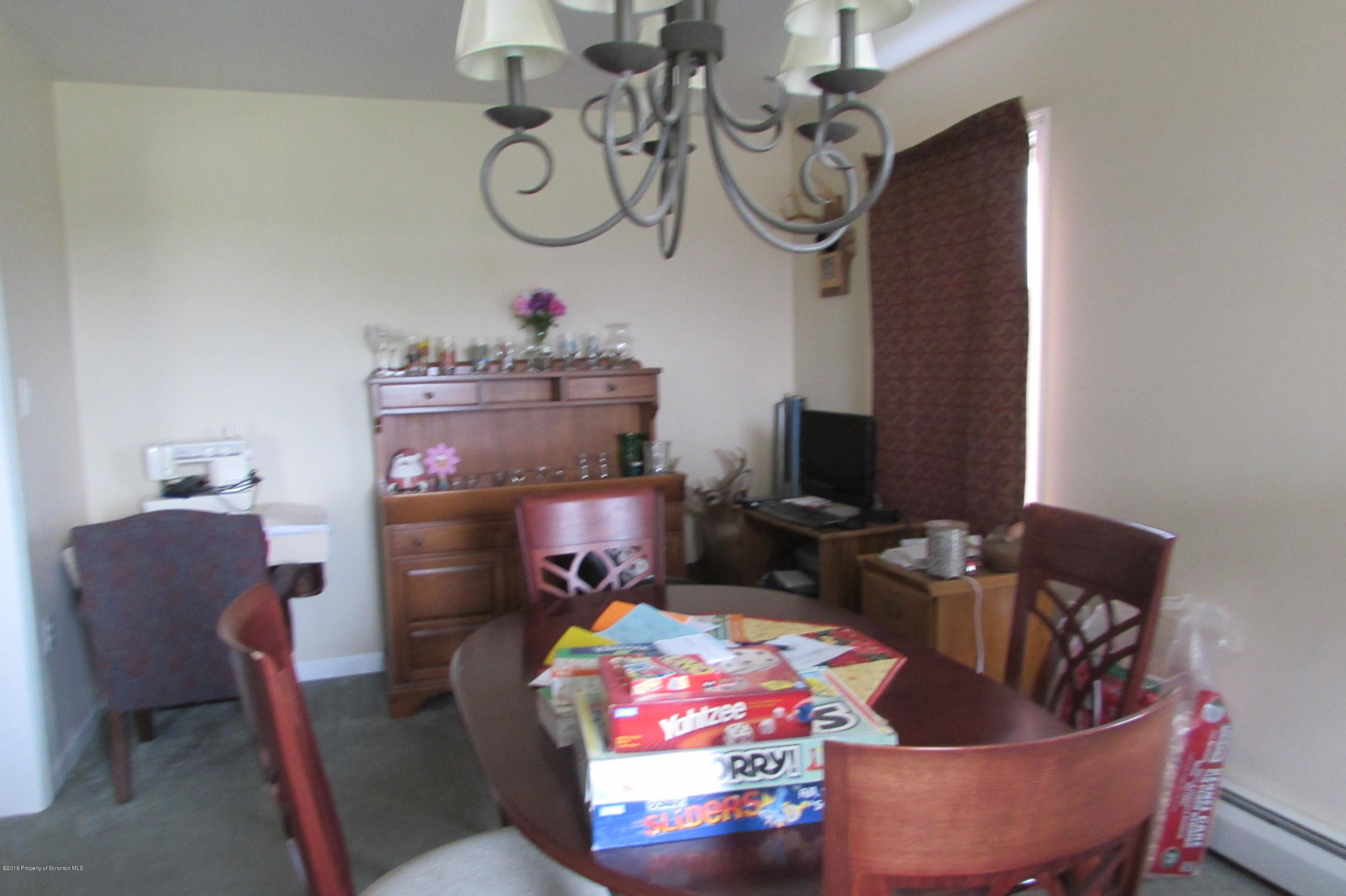 637 Craig Hill Road Meshoppen, PA 18630 - Photo 5 of 22 a living room with furniture a flat screen tv and a fireplace